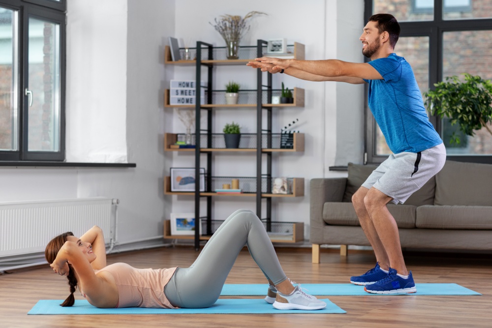 couple performing home exercise