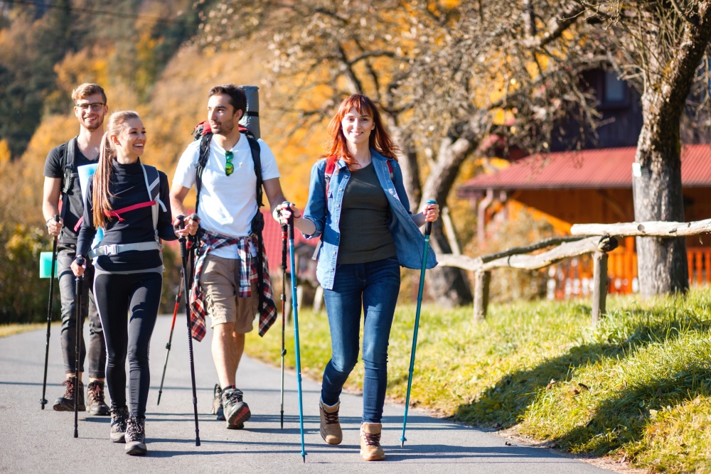 group of people walking with trekking poles