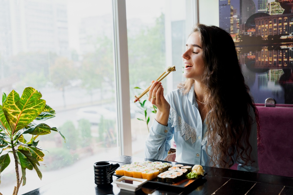 female mindful eating sushi
