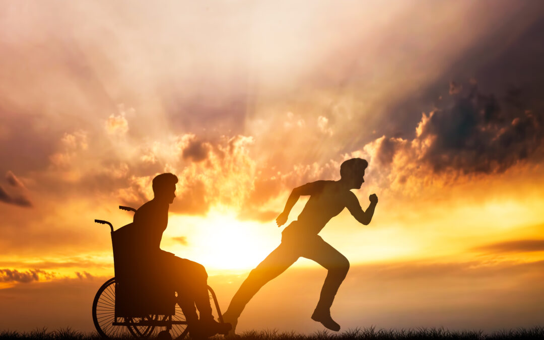 man sitting in a wheelchair with another man running with a sunset background