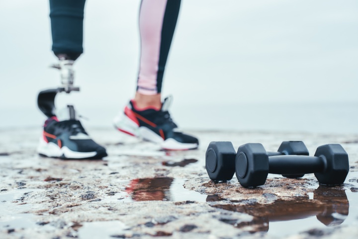 image of prosthesis with dumbbells on the ground